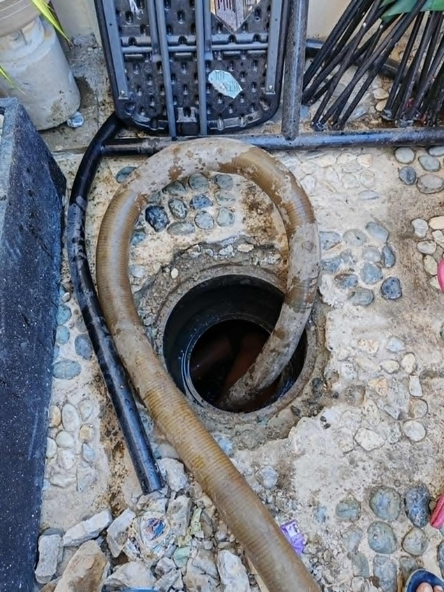 Our team clearing a stubborn drain clog using advanced plumbing equipment
