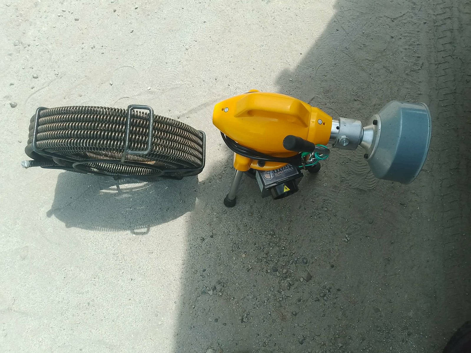 Our team clearing a stubborn drain clog using advanced plumbing equipment